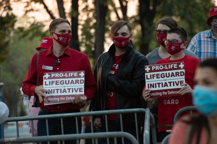 Lifeguard Initiative members holding signs at a rally