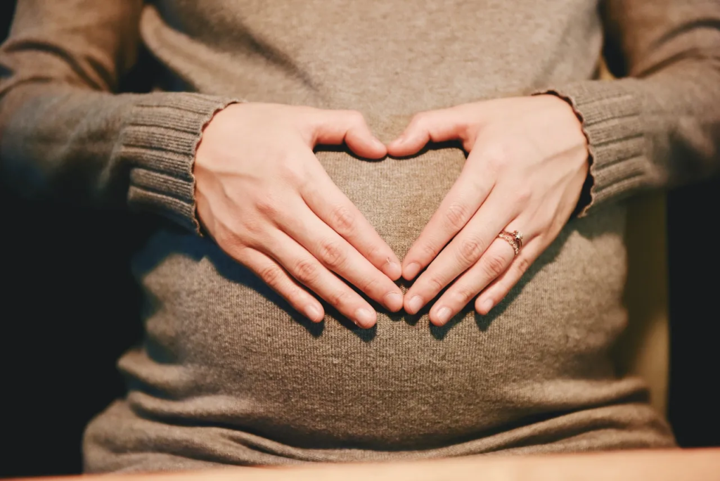 Ectopic Pregnancy: The Rare Hope Beyond Abortion Pregnant woman forming a heart shape with her hands over her abdomen