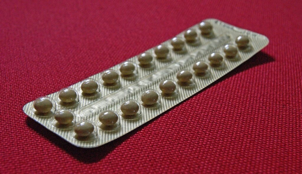 Contraception and the Pro-Life Movement Blister pack of contraceptive pills on red fabric.