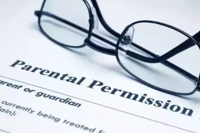 Parental permission form with eyeglasses